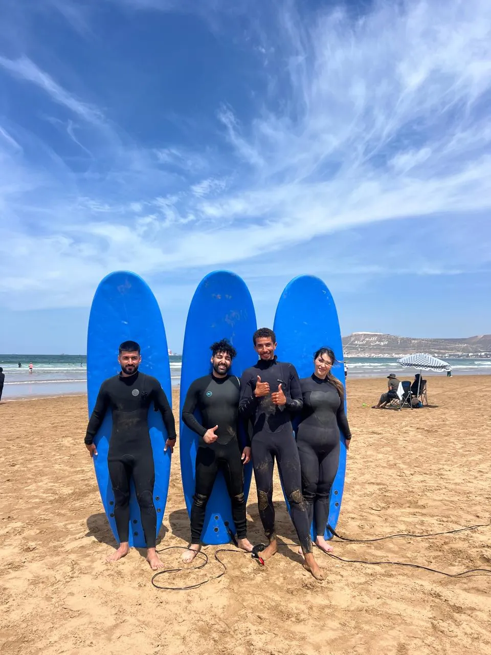 Simo leading a warm-up routine with surf students before an Agadir surf session